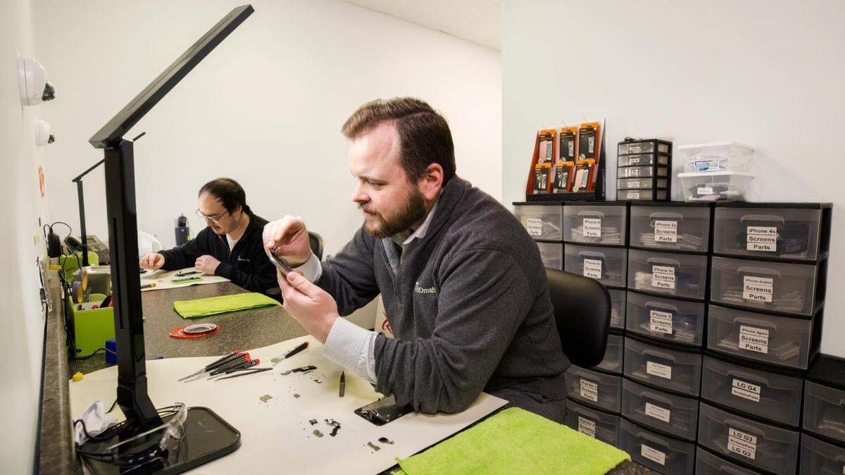 iFixAmerica founder Jason DeWater repairs a device