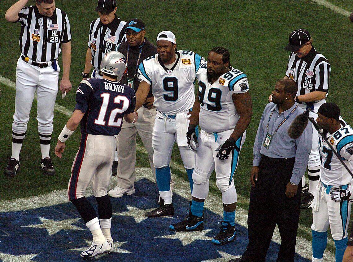 2/1/04: New England Patriots quarterback (#12) Tom Brady, left, shakes hands with the Carolina Panthers’ (#9) Rodney Peete as (#99) Brentson Buckner and (#87) Muhsin Muhammad watch the coin toss at the start of Superbowl XXXVIII played Sunday, Feb. 1, 2004 at Reliant Stadium in Houston TX.