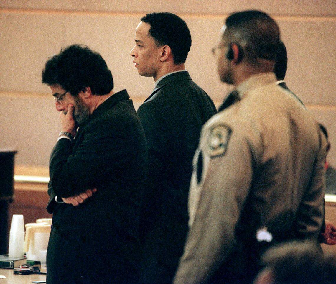 Defense attorney David Rudolf, left, and defendant Rae Carruth stand to hear the verdicts announced. Carruth showed no outward emotion when he was acquitted of first-degree murder in the death of Cherica Adams but found guilty of conspiracy to commit murder and two other charges, resulting in a sentence of nearly 19 years.