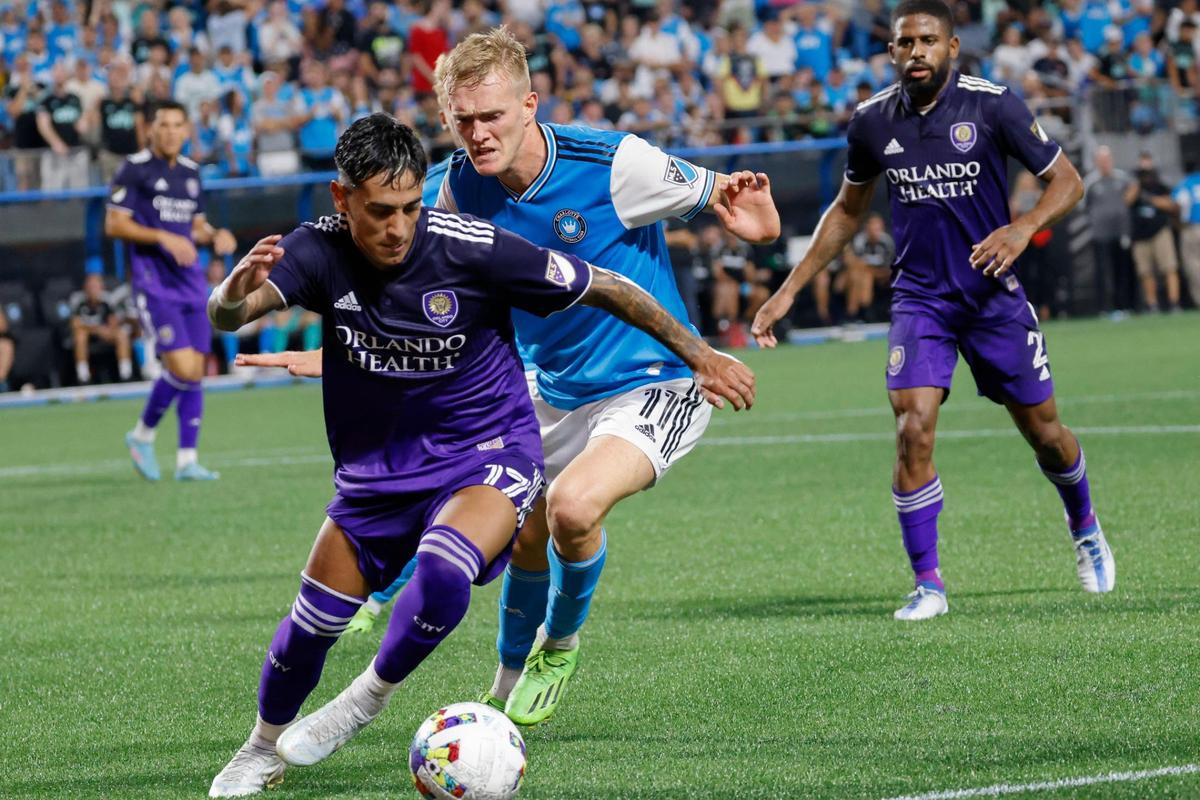 Charlotte FC forward Karol Swiderski (11) puts pressure on Orlando City forward Facundo Torres (17) in the second half in Charlotte, N.C., Sunday, Aug. 21, 2022.