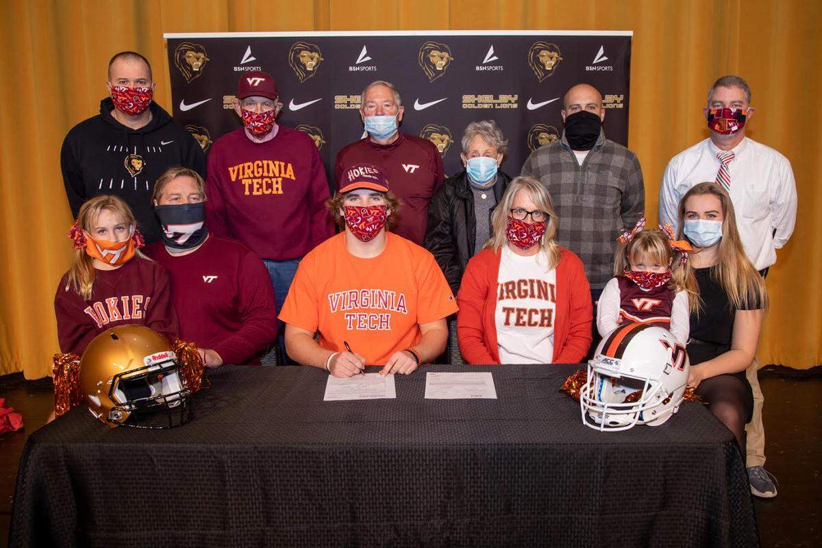 Shelby High star Jack Hollifield signed with Virginia Tech Wednesday. Seated (Left to Right): &nbsp;Ellie Hollifield (sister), Aubrey Hollifield (dad), Jack Hollifield, Jenny Hollifield (mom), JoJo Hollifield (sister), Belle Hollifield (sister),Standing (Left to Right): &nbsp;AD/Coach Mike Wilbanks, Jim Reid, Dale Hollifield (Grandfather), &nbsp;Dianne Hollifield (grandmother), Coach Justin Hawn, Principal David Allen