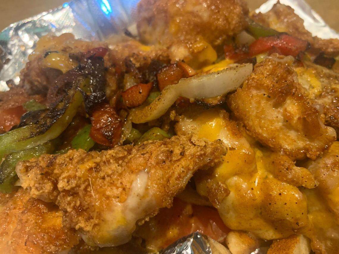 The Gastonia Cajun Loaded Fries were topped with mixed cheese, onions, peppers, tomatoes and fried chicken breast.