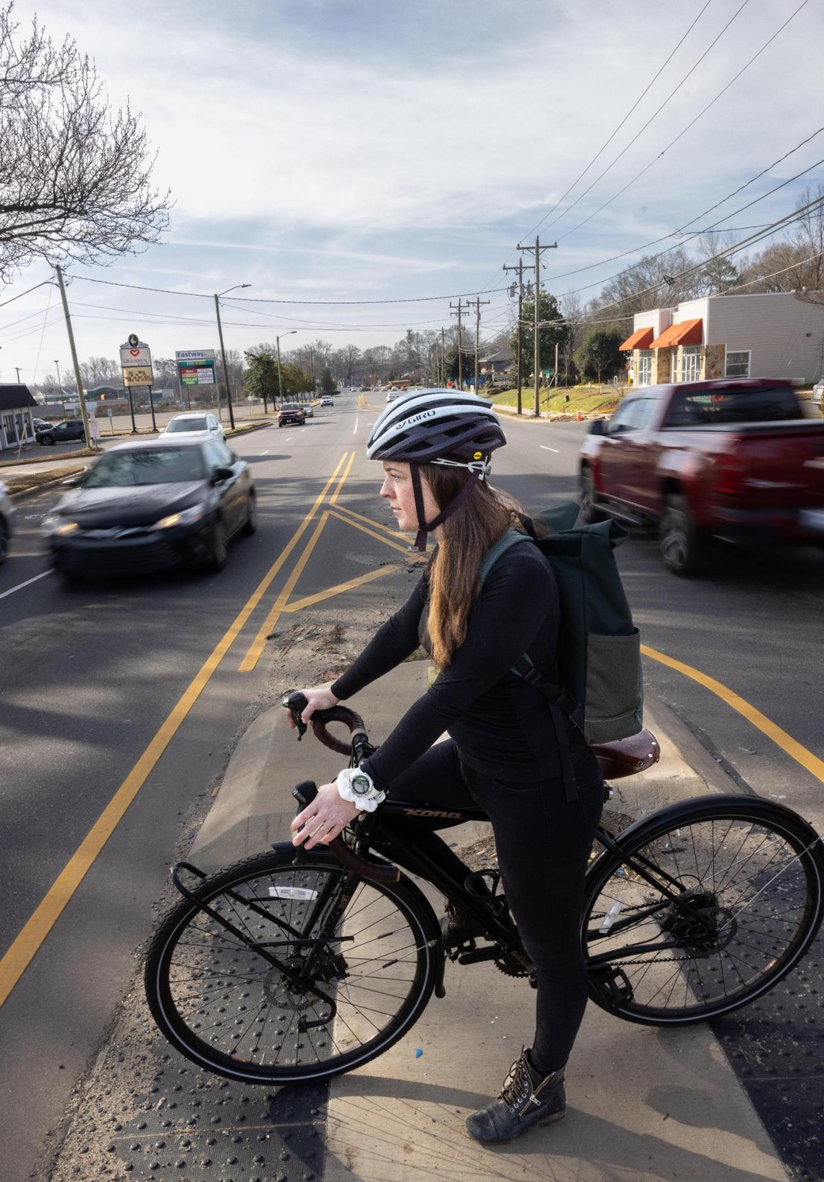 Laurel Yohe stops in the middle of Eastway Drive on a small island for pedestrians to cross in the Eastway Recreation Center in Charlotte, N.C., on Tuesday, February 7, 2023.