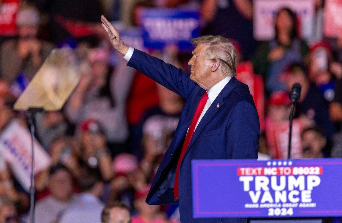 Former President Donald Trump acknowledges the crowd while leaving the stage following a rally speech at Minges Coliseum in Greenville on Monday, Oct. 21, 2024.