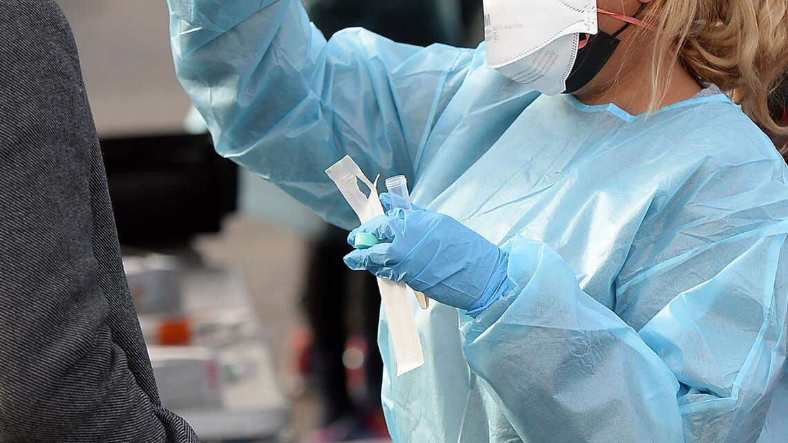 COVID tester Kaitlyn Monrobert tests a client at StarMed Healthcare on Tuckaseegee Road in Charlotte. Testing demand may lessen if the COVID virus becomes less dangerous, But it’s likely that testing — and even mass testing sites — are around for the long run.