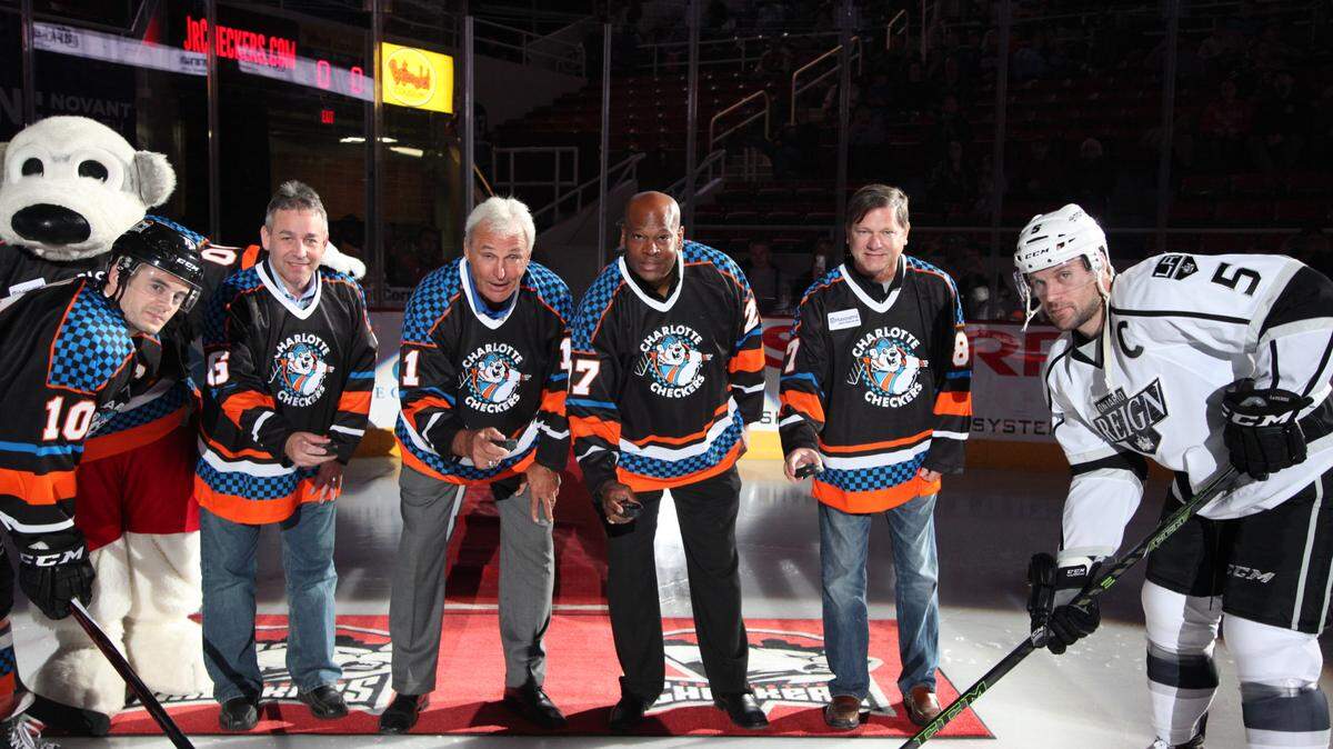 Shawn Wheeler (third from right) poses for a photo at a Charlotte Checkers reunion in 2015 alongside other Checkers from the past, including his old coach John Marks (third from left).