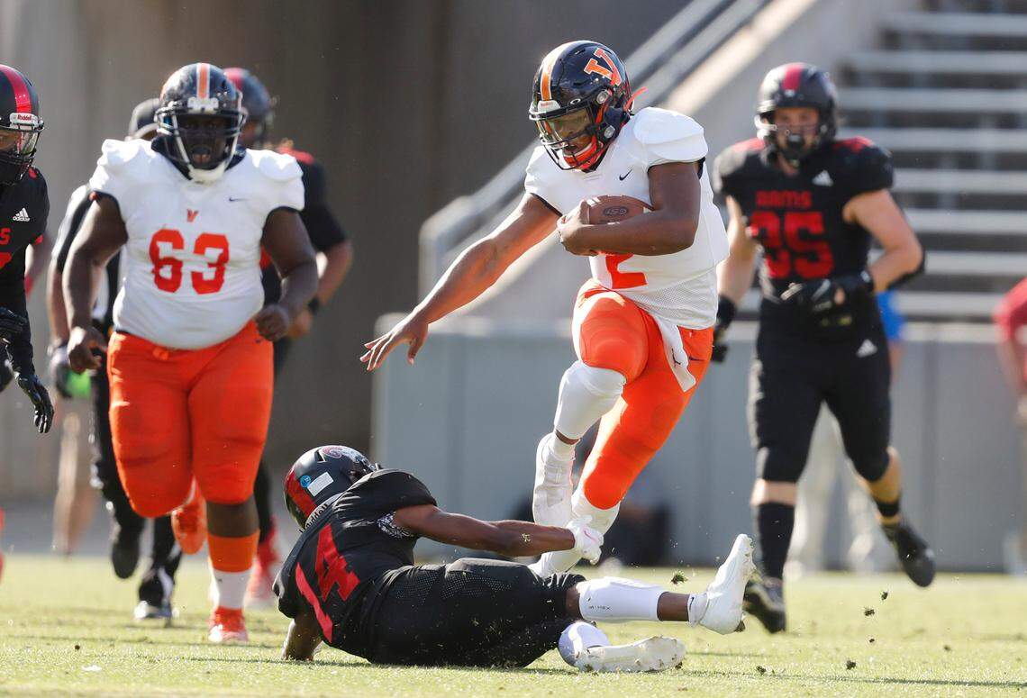 Vance’s Austin Grier (2) runs by Rolesville’s Kaireem Ingraham (14) during the first half of Rolesville High School’s game against Vance High School in the NCHSAA 4AA state championship at Carter-Finley Stadium in Raleigh, N.C., Saturday, May 8, 2021.