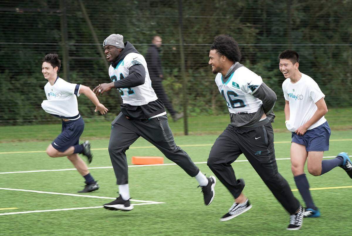 Carolina Panthers defensive end Efe Obada (second from left) was the main attraction with students from Harrow School on Thursday, when the NFL held a Play60 event after team practice.