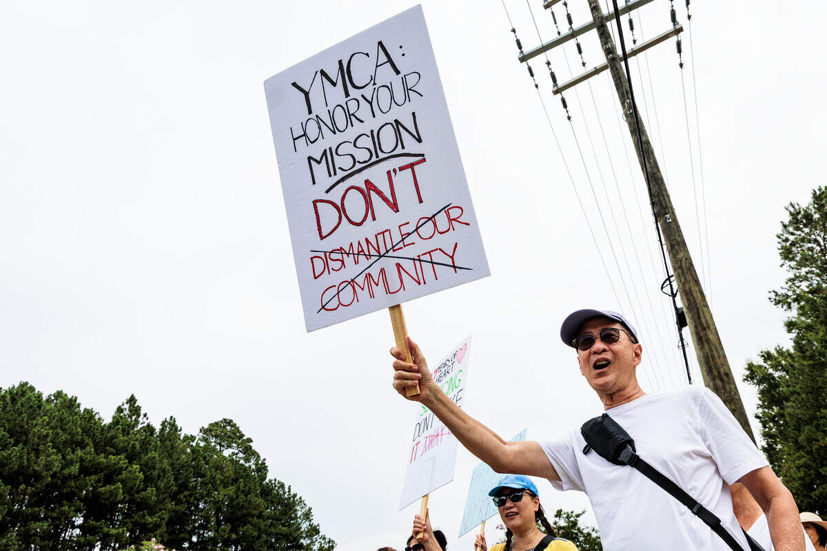 Al Nugroho protests the sale of the Morrison Family YMCA campus in Ballantyne to Moments of Hope Church on Sunday, July 12, 2026. “We make our friends here,” Nugroho said. “This is the central point of our life.”