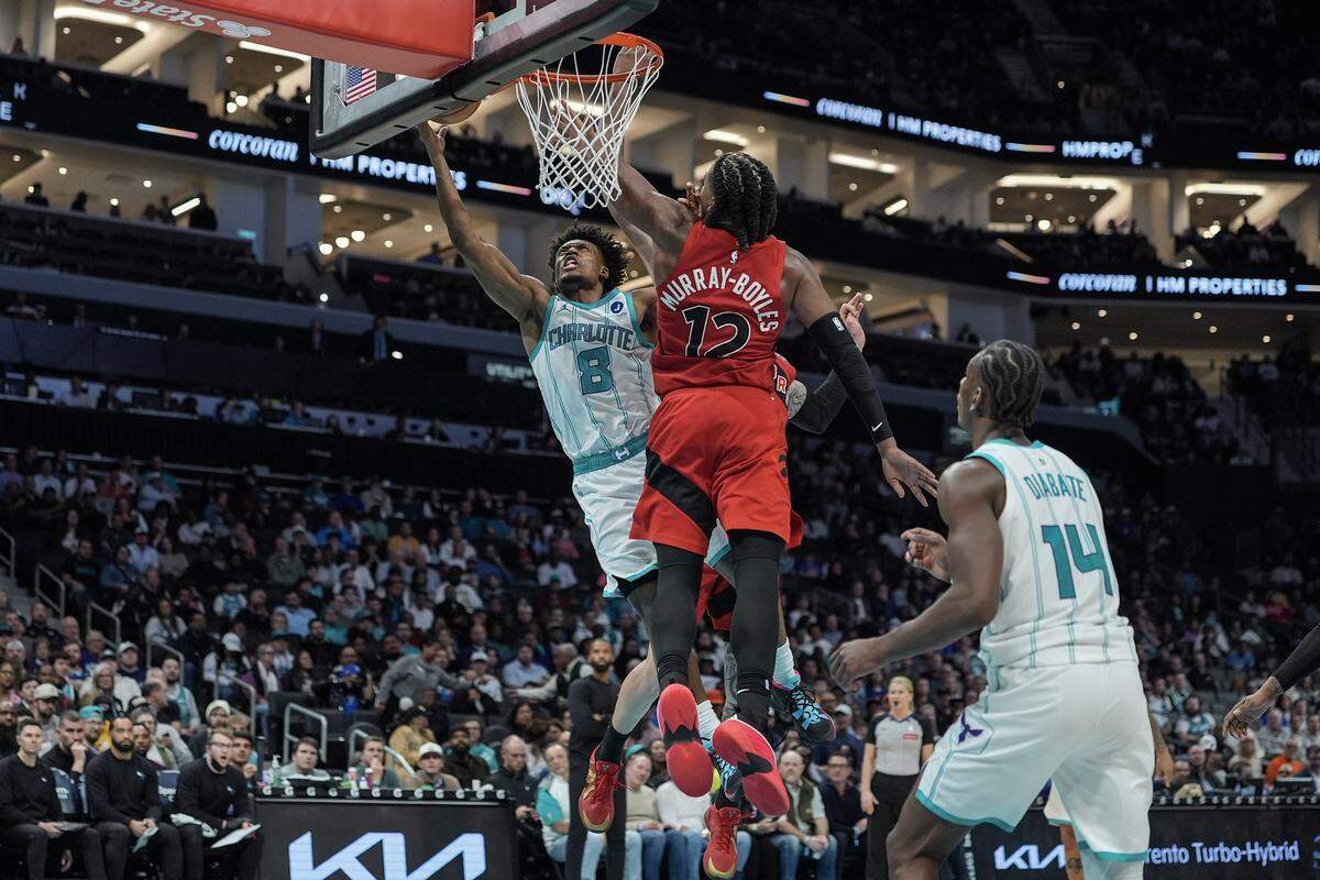 Charlotte Hornets guard Collin Sexton (8) drives to the basket against Toronto Raptors forward Collin Murray-Boyles (12) during the second half of an NBA basketball game, Wednesday, Jan. 7, 2026, in Charlotte, N.C.