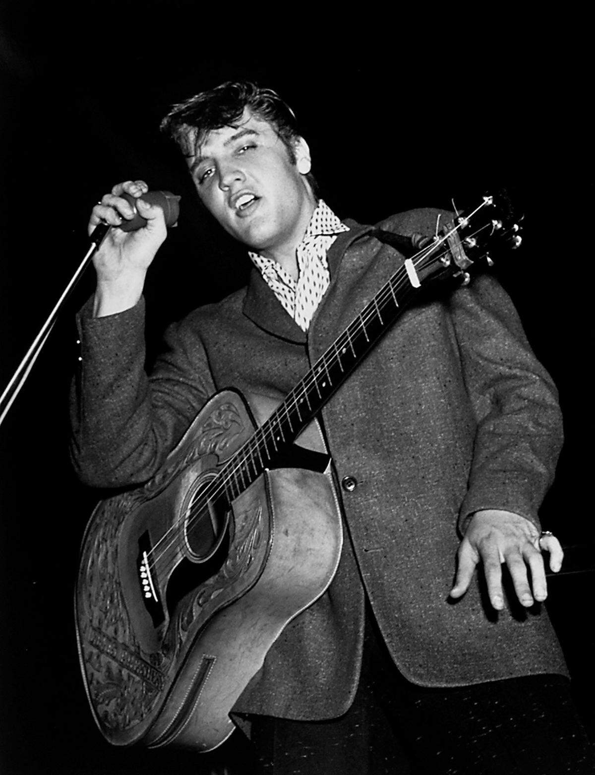 Elvis Presley performs his first show at the Charlotte Coliseum on June 26, 1956. Don Sturkey photographed him.