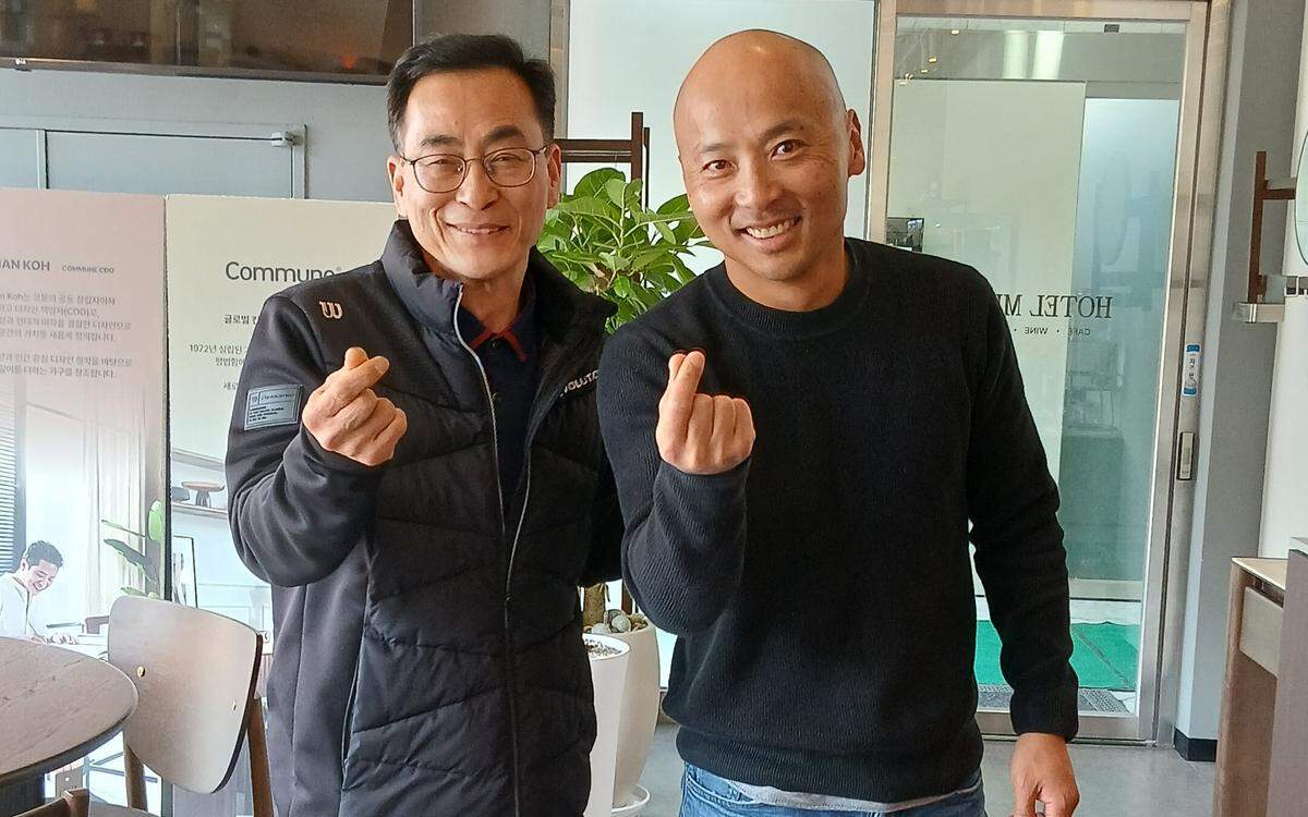 Jaehwan Woo, left, with Théoden Janes pose while making the Korean finger heart gesture after their reunion in Seoul.