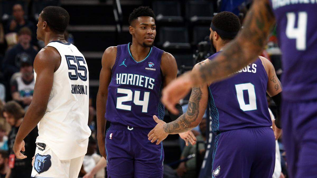 Charlotte Hornets forward Brandon Miller (24) reacts with forward Miles Bridges (0) during the first half at FedExForum.