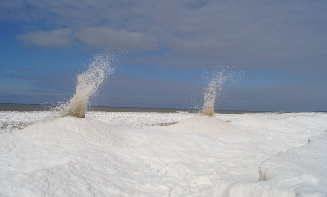 Waves interacted with the ice to created “ice volcanoes” along Lake Michigan beaches Sunday.