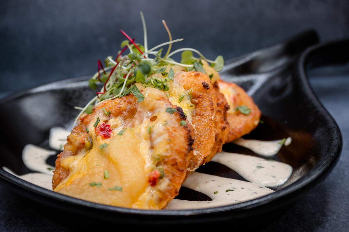 The Pump House’s popular fried green tomato appetizer is coated in cracker meal and served with house-made pimento cheese, tomato jam and roasted poblano ranch.