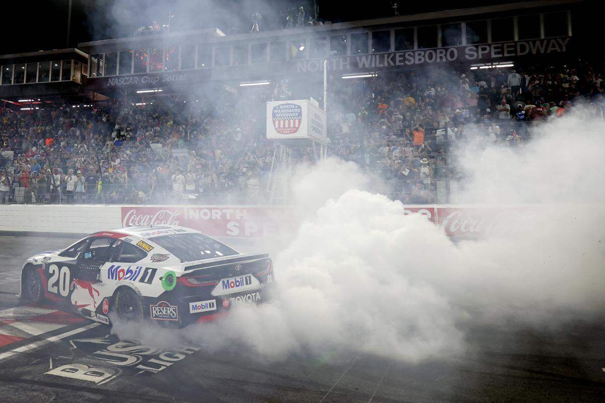 May 18, 2025; North Wilkesboro, North Carolina, USA; NASCAR Cup Series driver Christopher Bell (20) celebrates winning the NASCAR All-Star Race at North Wilkesboro Speedway.