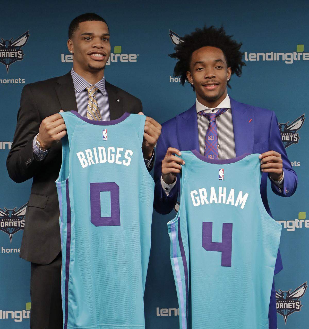 Charlotte Hornets draft picks Miles Bridges, left, and Devonte' Graham pose for a photo during a news conference for the NBA basketball team in Charlotte, N.C., Friday, June 22, 2018. (AP Photo/Chuck Burton)