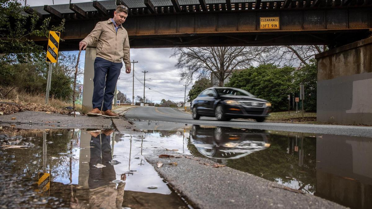 Paul Fretz stands by an area on Hawthorne Lane that floods often when it rains and causes cars to become trapped in Charlotte, N.C., on Friday, February, 16, 2022.
