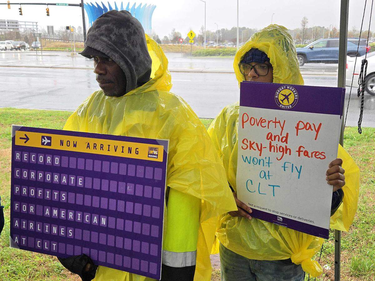 Charlotte airport workers and supporters push for higher wages during a rally hosted by the Service Employees International Union.