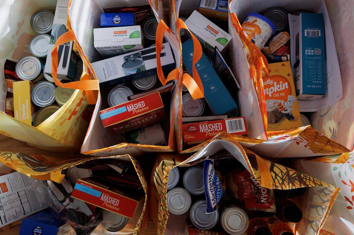 Fixings for Thanksgiving dinners — donated by neighbors of Dana Flaherty and members of the Facebook group she created — fill bags that the Willow Spring resident plans to take to families in Western North Carolina next week.