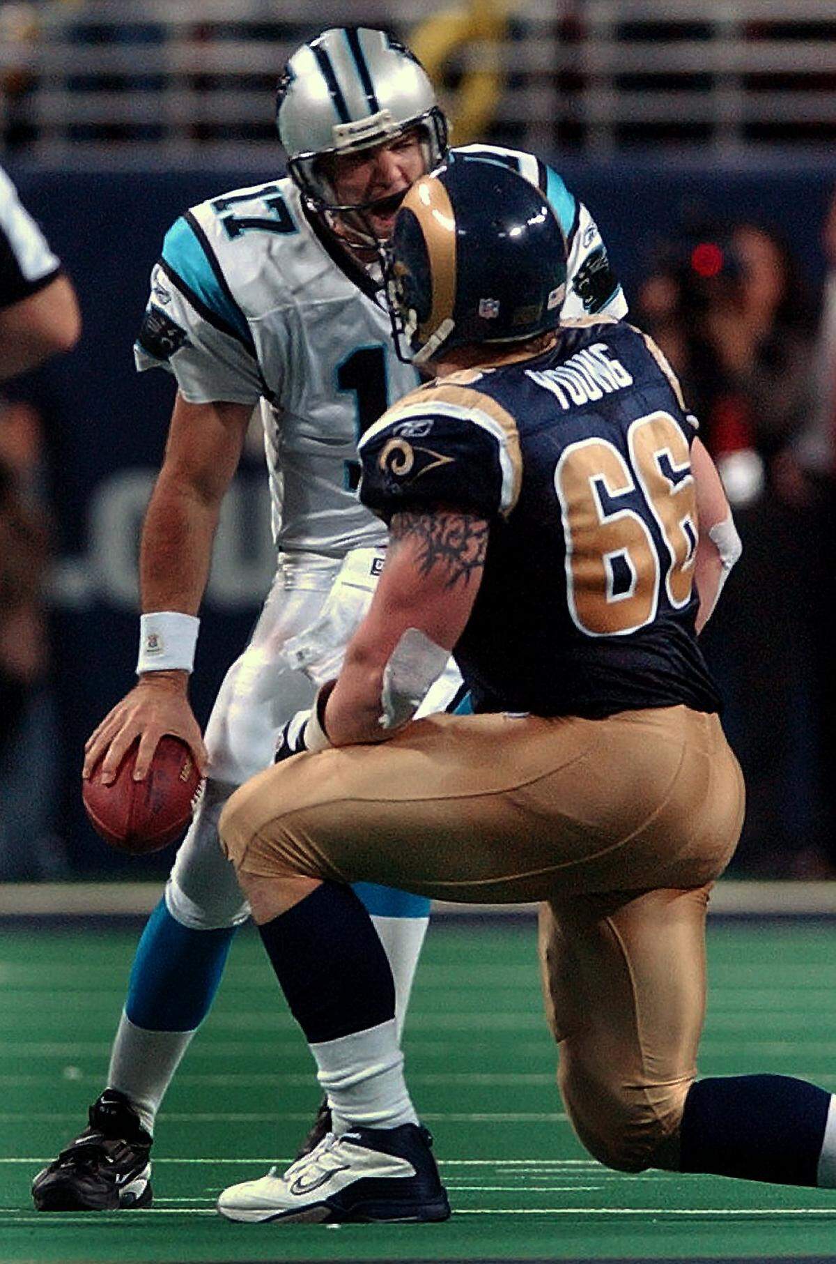 1/10/03 Carolina Panthers (17) quarterback Jake Delhomme yells at St. Louis Rams (66) defensive tackle Brian Young after the latter sacked Delhomme during overtime action. The Panthers defeated the Rams 29-23 in overtime. JEFF SINER/STAFF