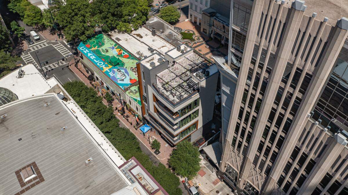 Vijay Bhojwani, president of Binaco Real Estate, wanted to give back to the city with the mural he commissioned Alex Duncan to create atop the building at 123 East 5th St. in uptown Charlotte.