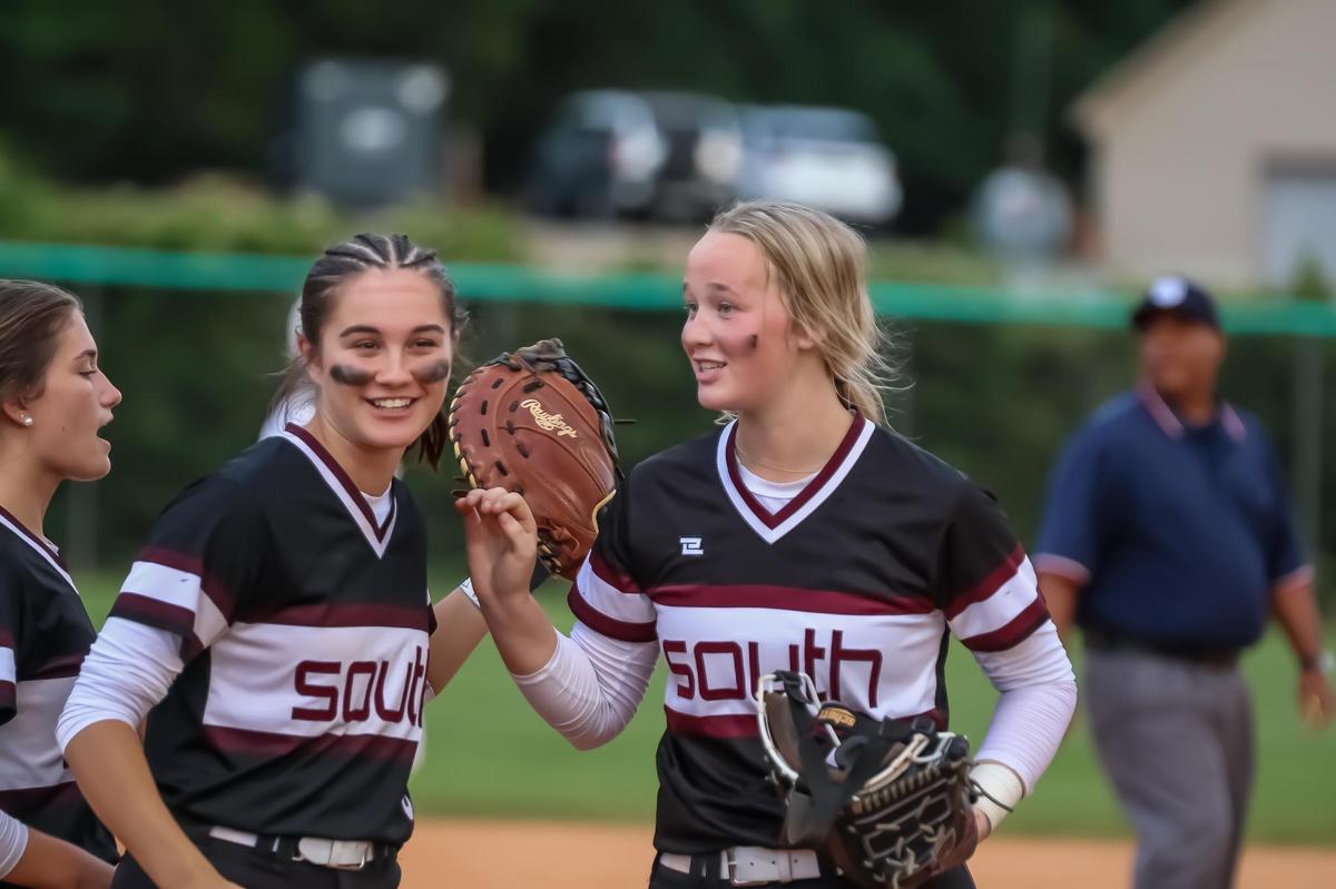 South Caldwell teammates high-five on the field after winning the softball championship game at Game 1 of the NCHAA regional championship series in May 20th, 2025 at Weddington high school in Weddington, NC