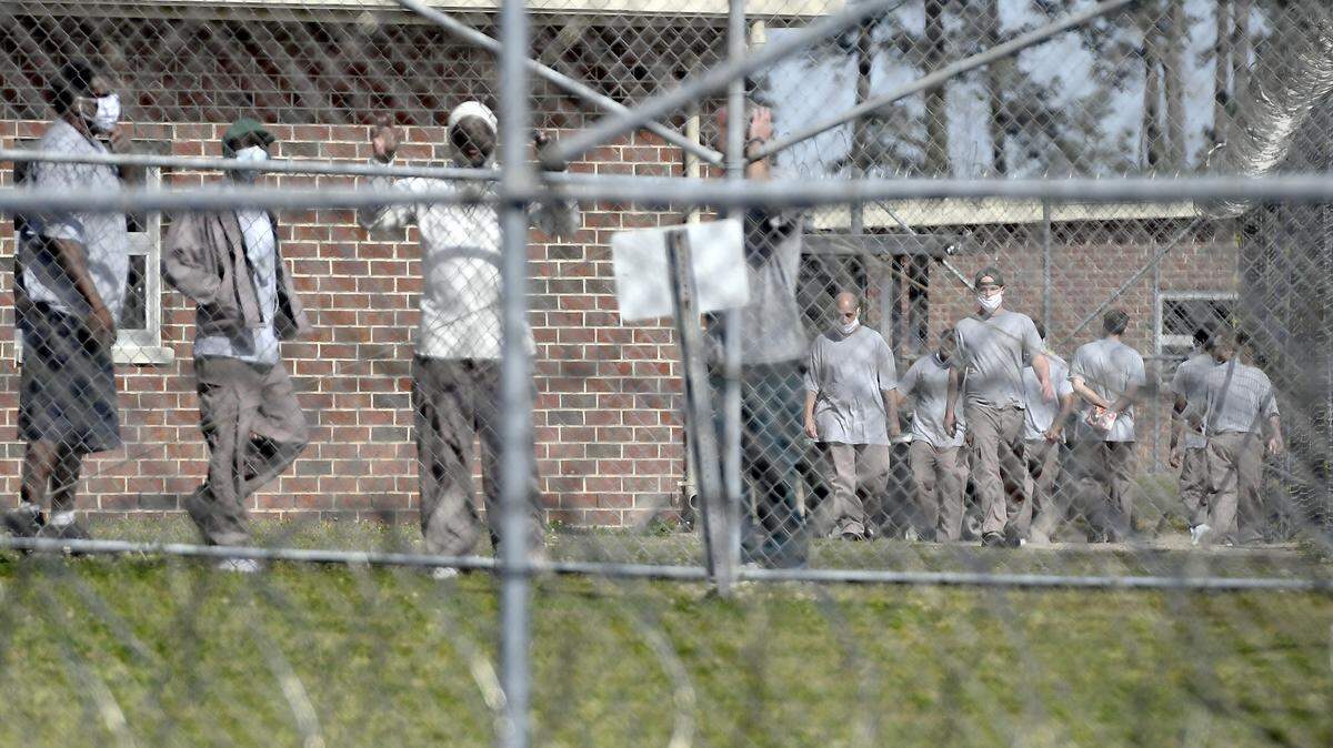 Inmates at Neuse Correctional Institution, in Goldsboro, N.C., move between buildings. More than 460 of the prison’s inmates have tested positive for COVID-19, making it one of the hardest-hit prisons in the nation.