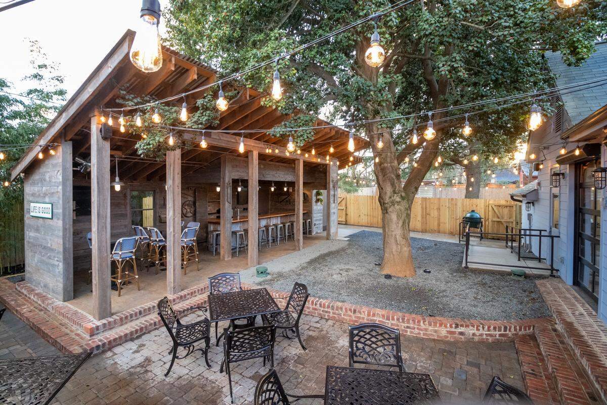 The backyard of The Goodyear House includes a rare large American holly tree.