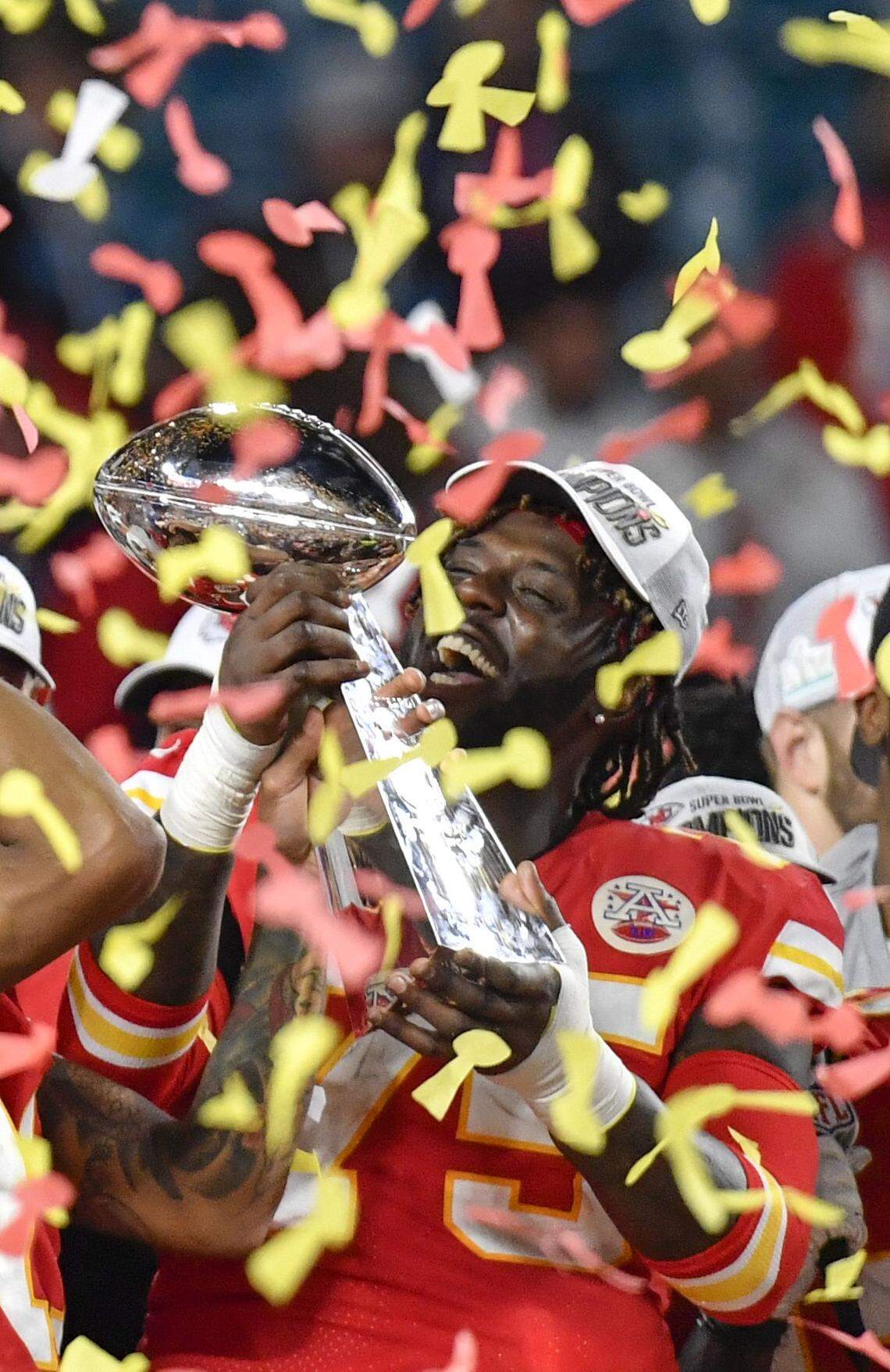 During the post game celebration, Chiefs Cam Erving hoists the Vince Lombardi Trophy after the Chiefs defeated the San Francisco 49ers, 30-21, in Super Bowl 54 on Sunday, Feb. 2, 2020 in Hard Rock Stadium in Miami.