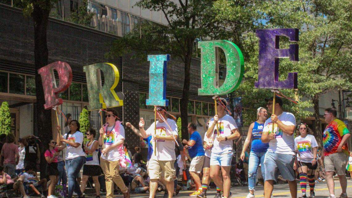 Charlotte Pride on Wednesday condemned company’s and institutions for rolling back diversity, equity and inclusion programs. Showm, paradegoers hold up letters spelling out “pride” during the 2023 Charlotte Pride Parade.