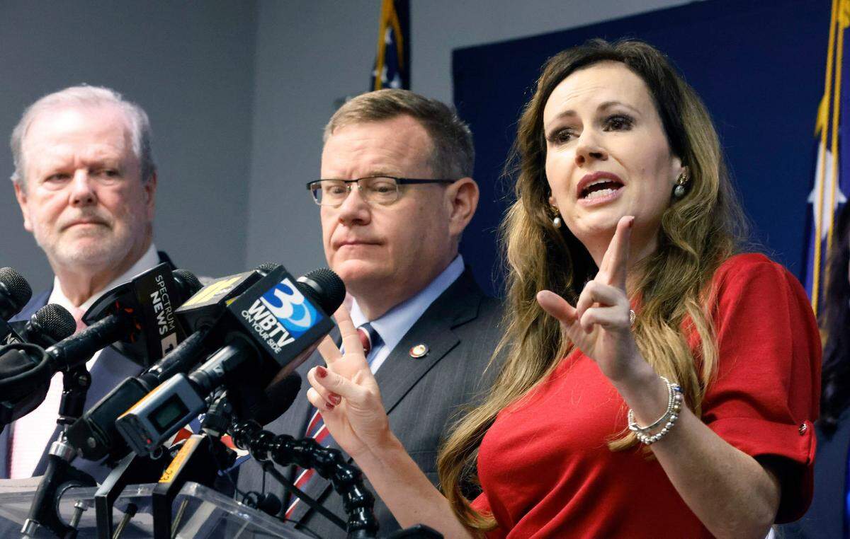 N.C. Senate leader Phil Berger, left, and House Speaker Tim Moore, center, look on as N.C. State Rep. Tricia Cotham speaks during a press conference at the N.C. GOP headquarters in Raleigh on April 5, 2023. The press conference was to announce Rep. Cotham is switching parties to become a member of the House Republican caucus.