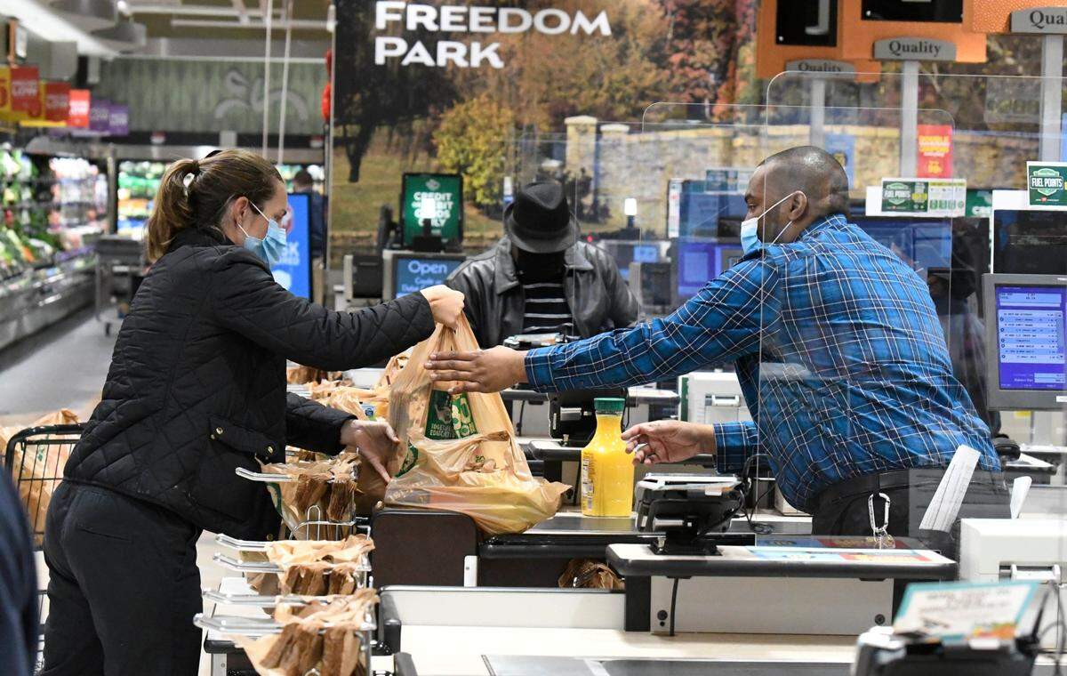 Customers checkout at the newly reopened Harris Teeter in the Park Road Shopping Center on Wednesday, January 13, 2021. The store originally opened in 1984 and served thePark Road the for nearly 36 years before temporarily closing for remodeling in January 2020. The 34,000 square foot store has 6 checkouts and 8 express checkouts and features include store made pizzas, a beer and wine bar, and fresh sushi. 