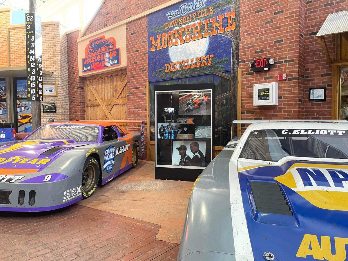 Cars from Tony Stewart’s Superstar Racing Experience series driven by Chase and Bill Elliott sit side-by-side at the entrance of the Georgia Racing Hall of Fame.