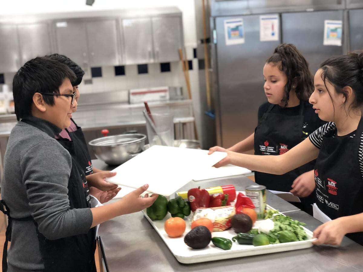 Students from the Creative Players Foundation prepare for the Kids Cook With Heart competition in Charlotte on Oct. 26.