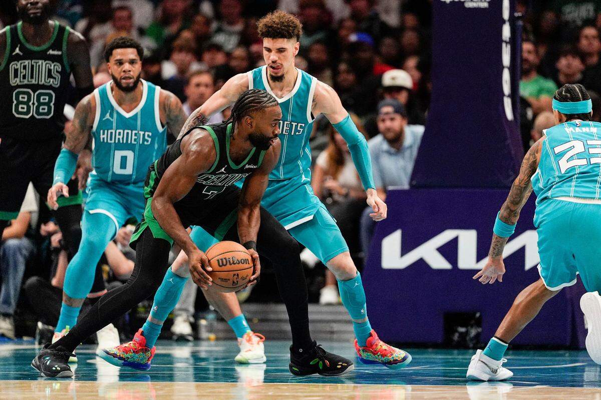Nov 1, 2024; Charlotte, North Carolina, USA; Charlotte Hornets guard LaMelo Ball (1) guards Boston Celtics guard Jaylen Brown (7) during the second half at the Spectrum Center. Mandatory Credit: Jim Dedmon-Imagn Images