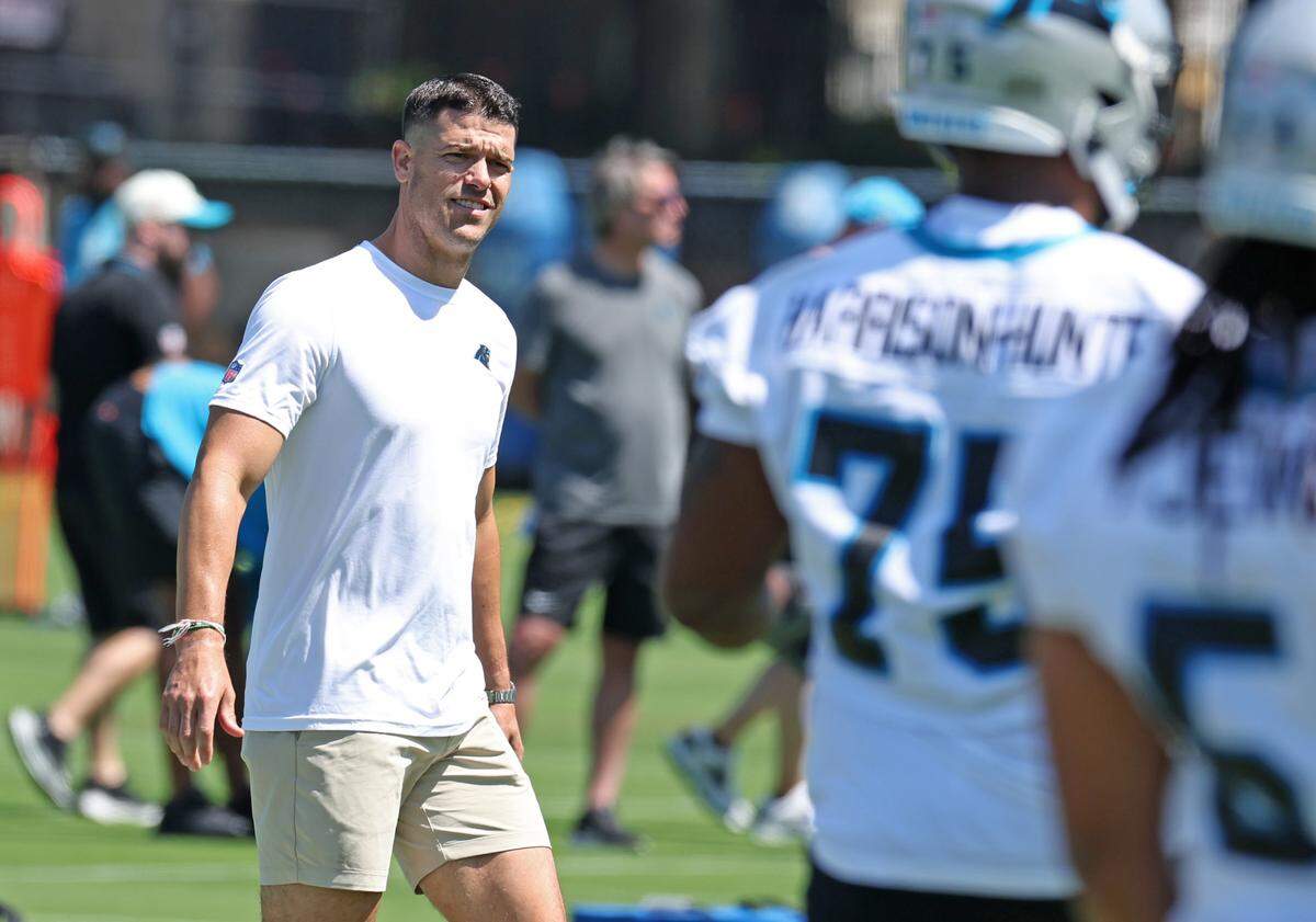 Carolina Panthers head coach Dave Canales walks around the field watching players run through stretching drills during the team’s rookie minicamp practice on Friday, May 9, 2025.