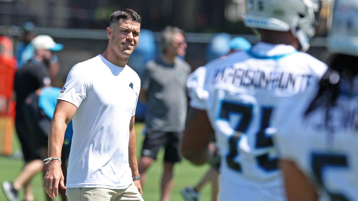Carolina Panthers head coach Dave Canales walks around the field watching players run through stretching drills during the team’s rookie minicamp practice on Friday, May 9, 2025.