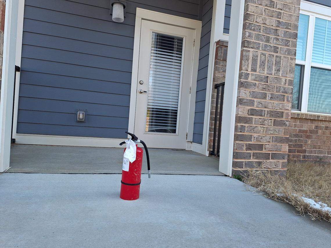 A fire extinguisher stands as a lone sentinel outside a three-story apartment building in the Pointe at Caldwell Station project off N.C. 115 in Huntersville, NC, on Thursday, Feb. 20, 2025.