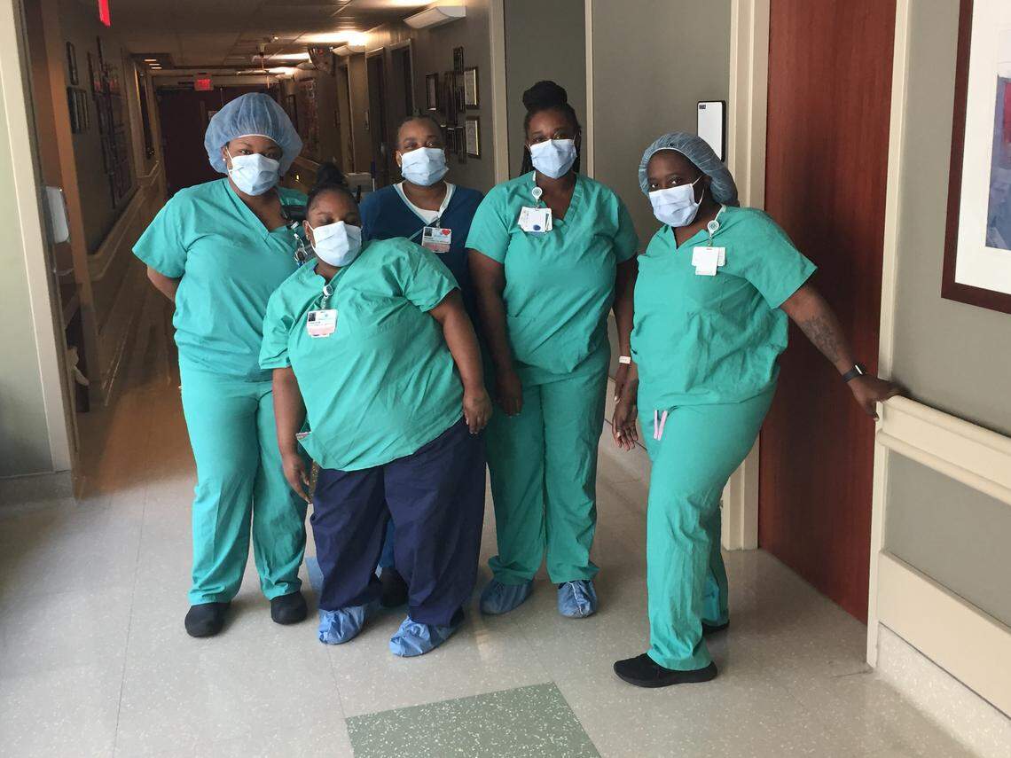 Tyresha Thompson (in blue scrub pants) with other members of the Atrium Health environmental services team.