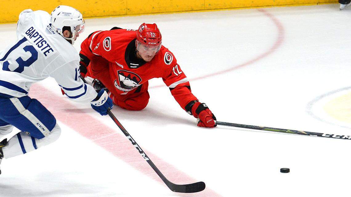 Charlotte Checkers right wing Julien Gauthier, right, stretches out in an attempt to get the puck as Toronto Marlies right wing Nicholas Baptiste, left, chases during first period action of the Eastern Conference Finals Game 1 at Bojangles’ Coliseum on Friday, May 17, 2019 in Charlotte, NC.