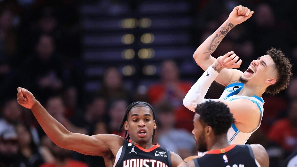 The Charlotte Hornets’ LaMelo Ball, top right, reacts during first-half action against the Houston Rockets’ Josh Christopher (9) and Tari Eason (17) at Toyota Center on Wednesday, Jan. 18, 2023, in Houston. (Carmen Mandato/Getty Images/TNS)