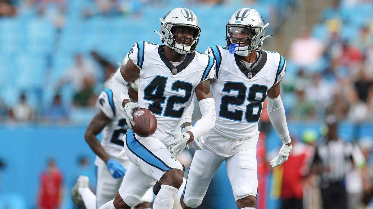 Panthers safety Sam Franklin, Jr., left, celebrates with teammate Keith Taylor, Jr. after intercepting a pass during the pre-season game against the Jets at Bank of America Stadium on Saturday, August 12, 2023 in Charlotte, NC.