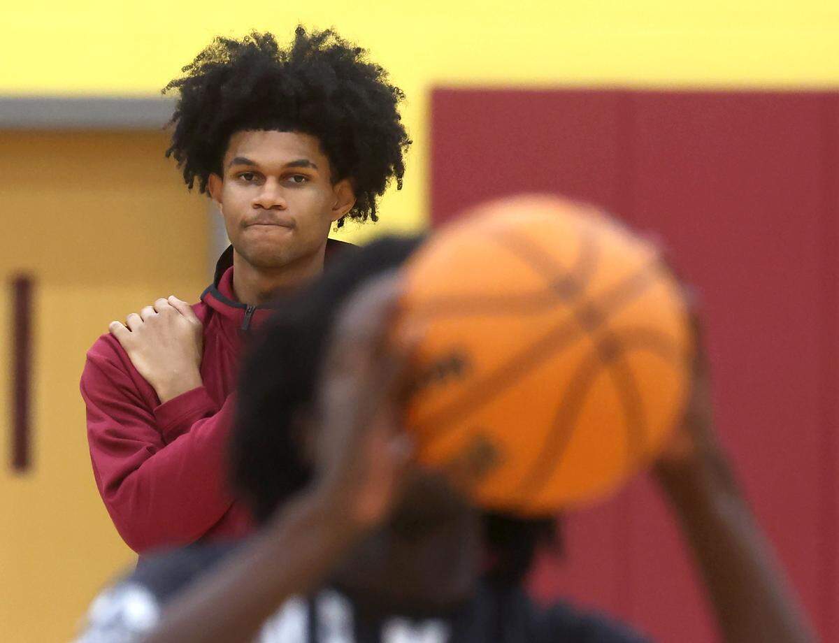 Janon Singh watches as members of the West Charlotte Lions basketball team warmup on Saturday, January 17, 2026. Singh, a junior is a top national recruit. West Charlotte hosted Hillside in a battle of traditionally black schools in the MLK Peace Basketball Showcase at West Charlotte High School in Charlotte, NC.