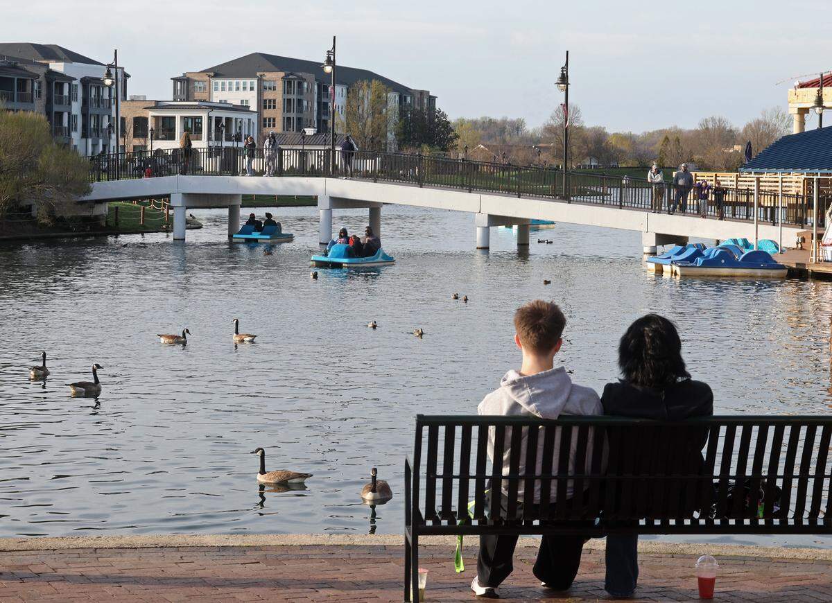 Families and couples enjoy the evening along The Boardwalk in the University City area on Friday, March 13, 2026. Despite its size, density and growth, The Boardwalk (formerly know as The Shoppes at University Place) University City area has not developed a good independent restaurant scene.