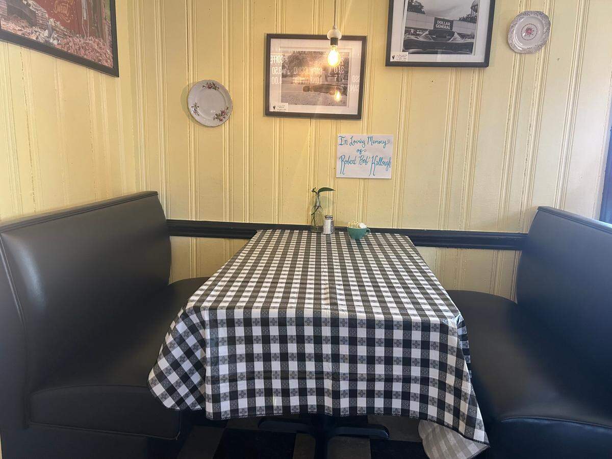 A note in memory of loyal customer Robert ‘Bob’ Killough sits above his seat in The Dish on Thomas Ave .