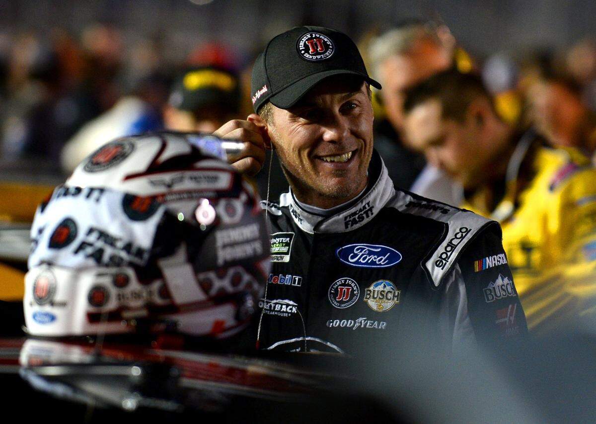NASCAR driver Kevin Harvick smiles at passerby along pit road prior to the first Can-Am Duel race at Daytona International Speedway on Thursday, February 23, 2017.