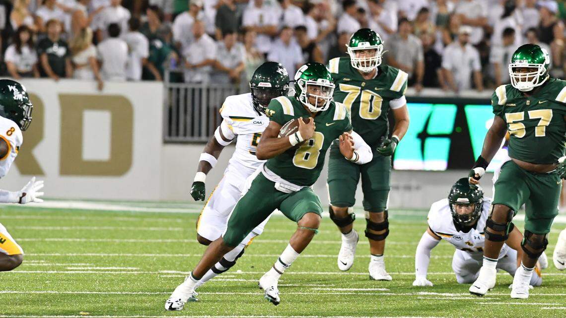 Charlotte 49ers quarterback Xavier Williams runs for a gain against William & Mary during the 49ers home-opener in Charlotte on Friday, September 2, 2022.