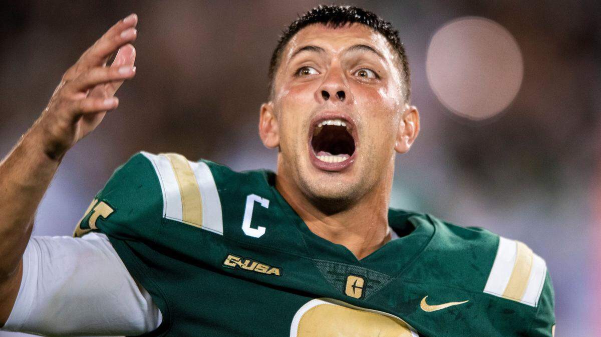 Charlotte 49ers’ quarterback, Chris Reynolds, sprays water from a bottle as he yells at the crowd to cheer for the team during the game Duke at Jerry Richardson Stadium on Friday, September 3, 2021 in Charlotte, NC. Charlotte beat Duke with a final score of 31-28.