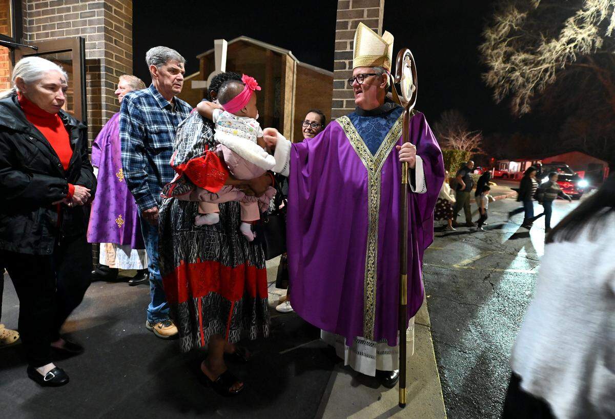 Bishop Michael Martin, center, greets parishioners following  an Ash Wednesday Mass at St. John Neumann Catholic Church in Charlotte, NC on Wednesday, February 18, 2026. 